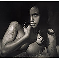 Tattooed eurasian beauty on fur in black and white