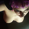 Purple haired chick in black fishnet gets naked