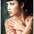busty tattooed naked Eurasian girl wearing horns