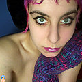purple haired chick in black fishnet gets naked